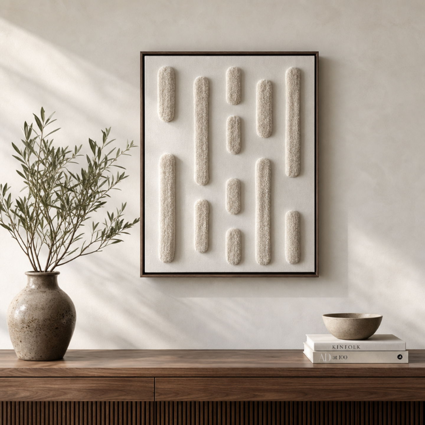 Pride textile artwork in cream tones beside an olive tree